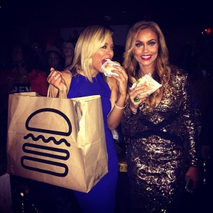 Robyn Dixon and Gizelle Bryant take a bite of Shake Shack at the premiere party at Sax (Photo by Erica Moody)